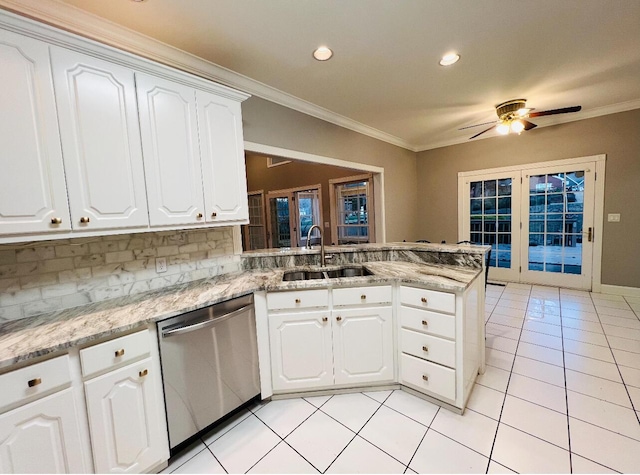 kitchen with dishwasher, white cabinets, light tile patterned flooring, and sink