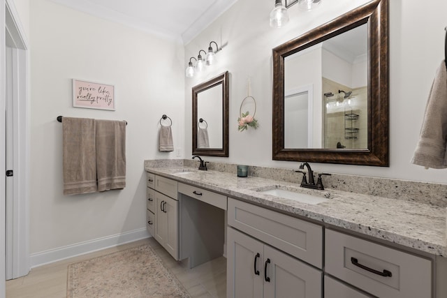 bathroom with vanity, a shower with door, and crown molding