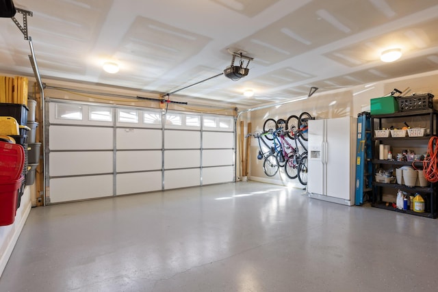 garage with white fridge with ice dispenser and a garage door opener