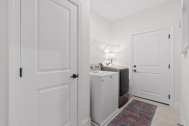 laundry area featuring light hardwood / wood-style flooring and independent washer and dryer