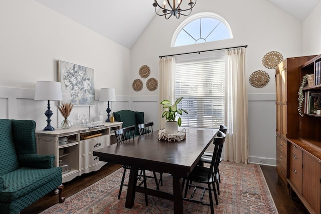 dining area featuring high vaulted ceiling, a chandelier, and dark hardwood / wood-style floors