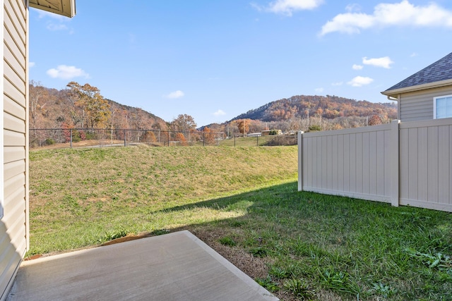 view of yard featuring a mountain view and a patio