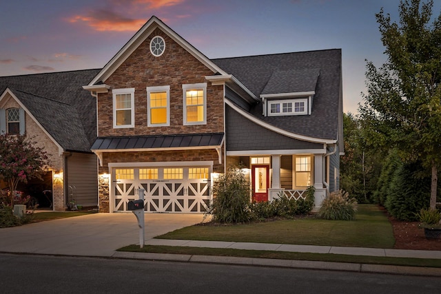 craftsman-style home featuring a lawn and a garage