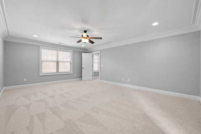 unfurnished room featuring crown molding, ceiling fan, and light colored carpet