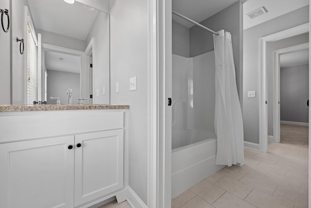 bathroom with tile patterned floors, shower / bath combination with curtain, and vanity