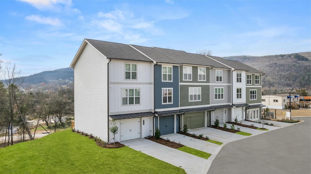 townhome / multi-family property with a mountain view and a front lawn