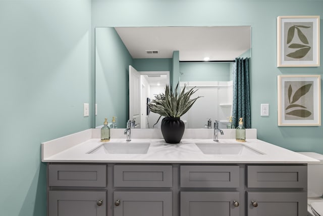 bathroom featuring vanity and toilet