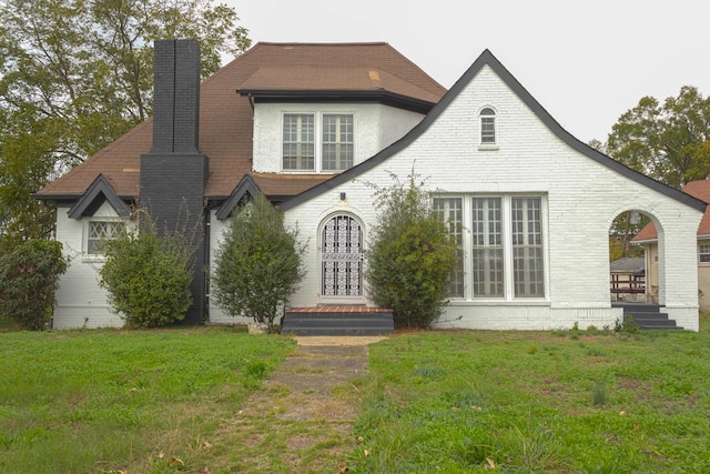 rear view of house with a yard