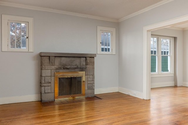 unfurnished living room featuring a stone fireplace, light hardwood / wood-style floors, and ornamental molding