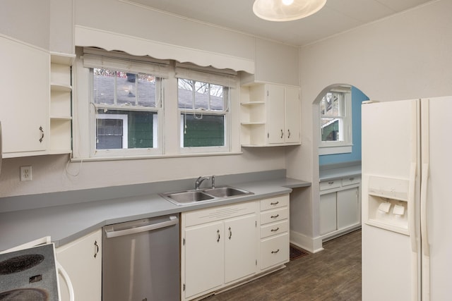 kitchen featuring dishwasher, white fridge with ice dispenser, white cabinets, and plenty of natural light