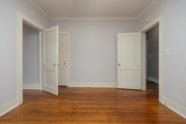 unfurnished room featuring dark hardwood / wood-style flooring and crown molding