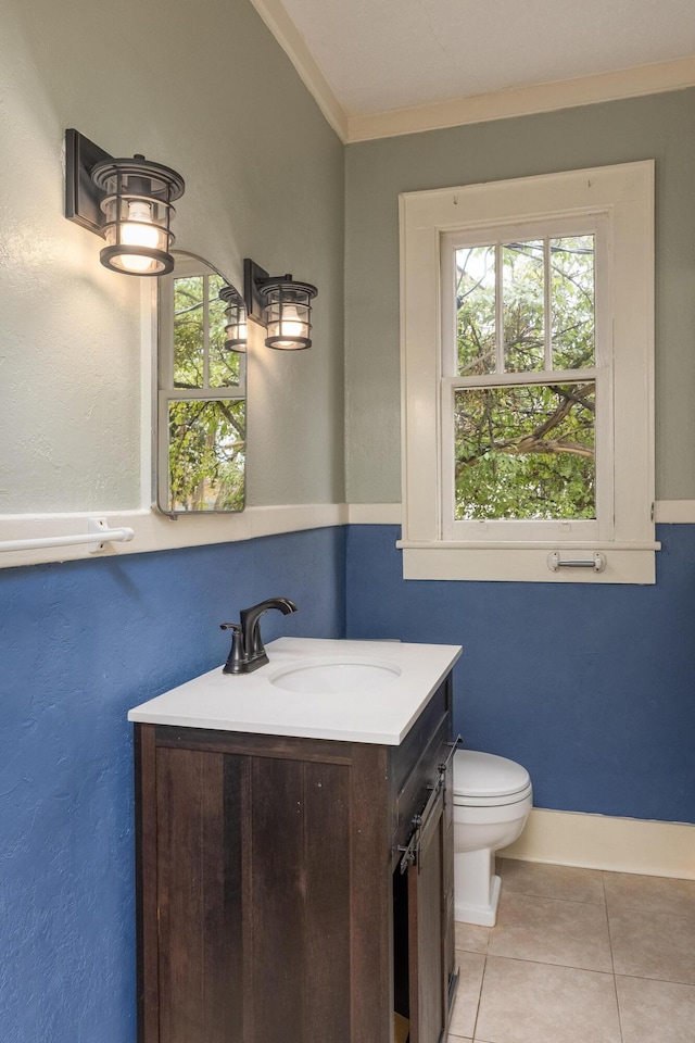 bathroom featuring tile patterned floors, toilet, vanity, and ornamental molding