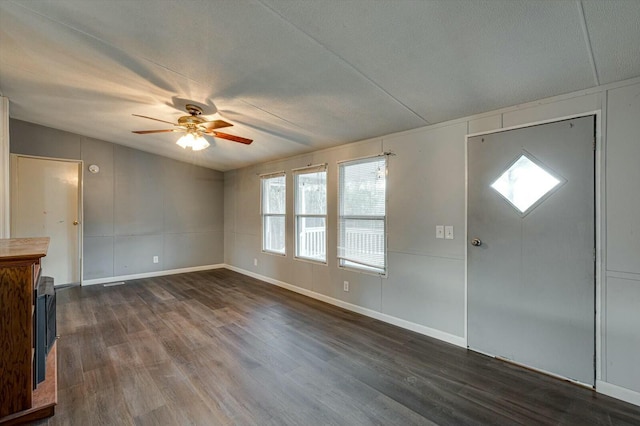 foyer entrance featuring a textured ceiling, dark hardwood / wood-style floors, and ceiling fan