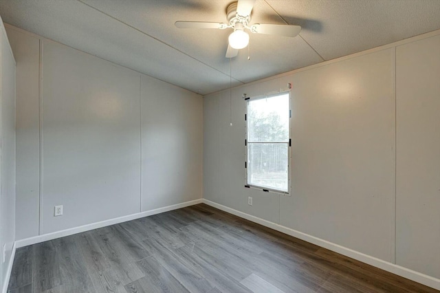 empty room with ceiling fan, light hardwood / wood-style floors, and a textured ceiling