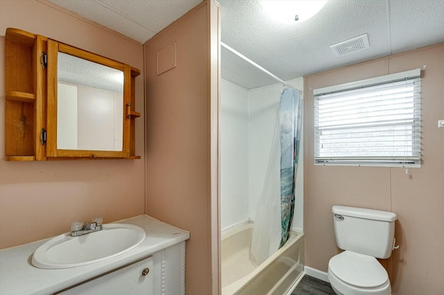 full bathroom with vanity, hardwood / wood-style flooring, toilet, a textured ceiling, and shower / tub combo with curtain