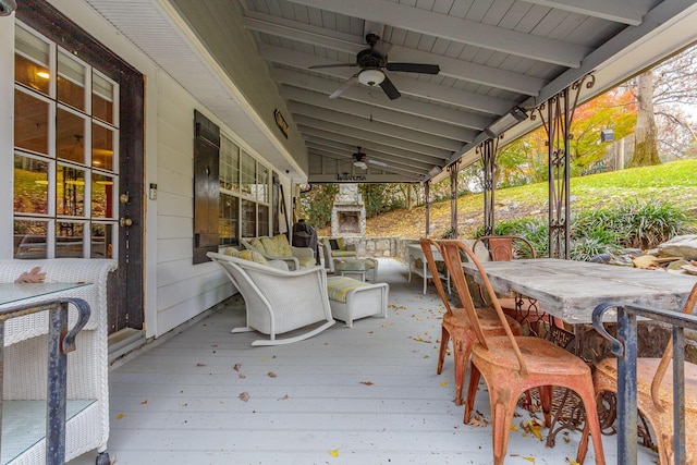 deck with ceiling fan and exterior bar