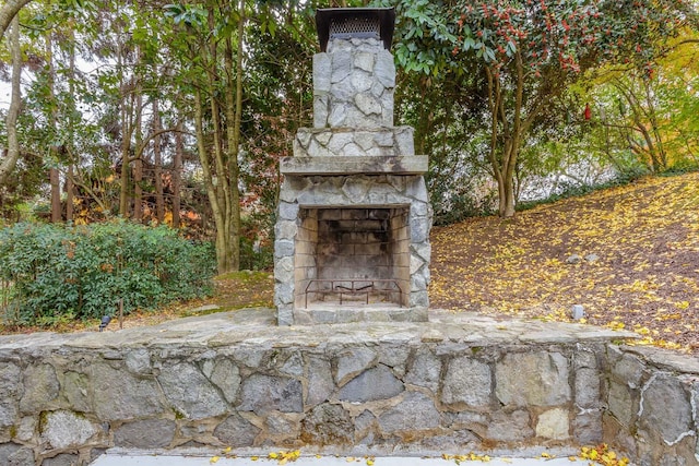 view of patio / terrace featuring an outdoor stone fireplace