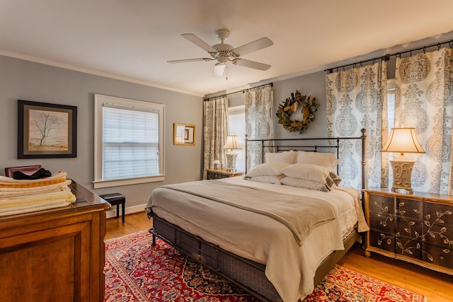 bedroom with light hardwood / wood-style flooring, multiple windows, and ceiling fan