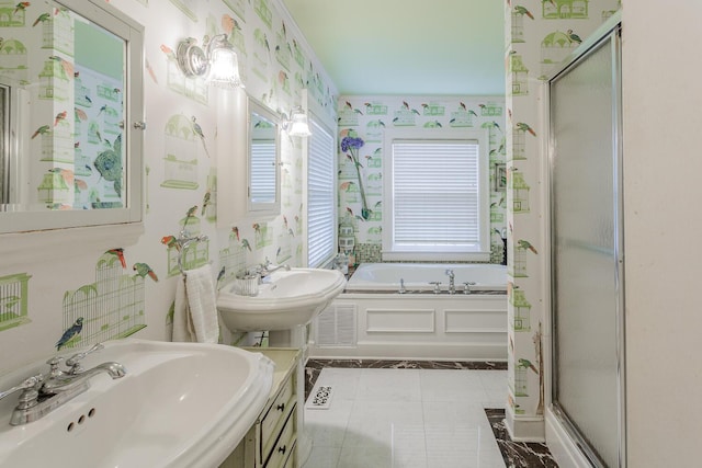 bathroom featuring tile patterned flooring, double sink, and plus walk in shower