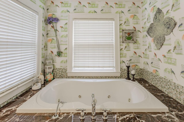 bathroom featuring tiled tub