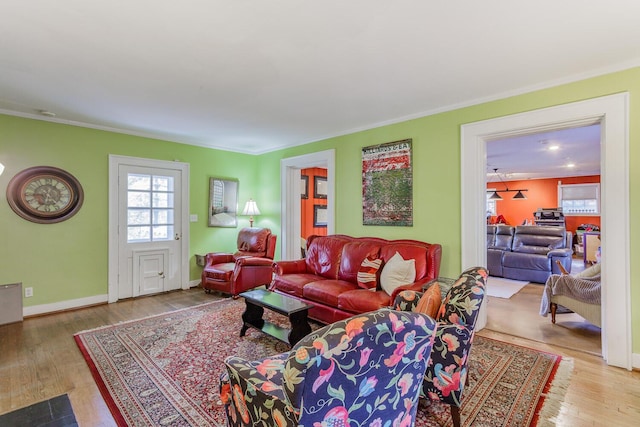 living room with crown molding and hardwood / wood-style flooring