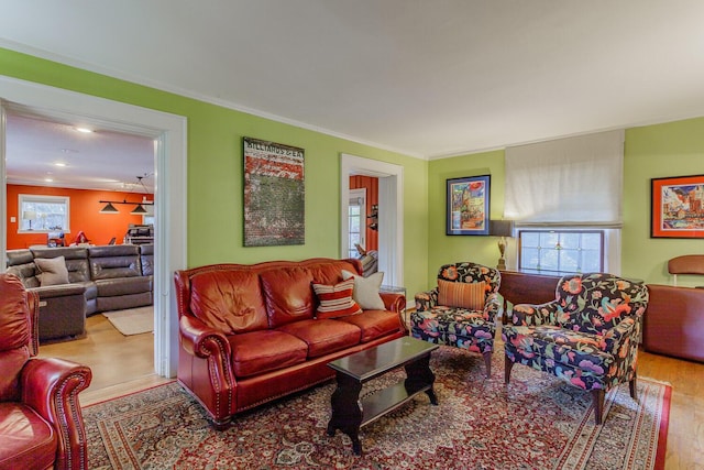 living room featuring hardwood / wood-style flooring and crown molding