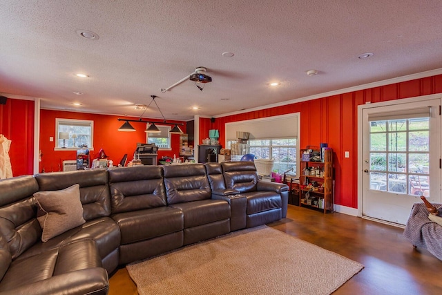 home theater with a textured ceiling and crown molding