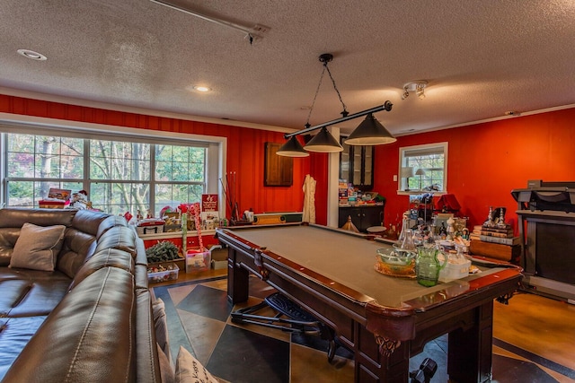 recreation room with a textured ceiling, crown molding, and pool table