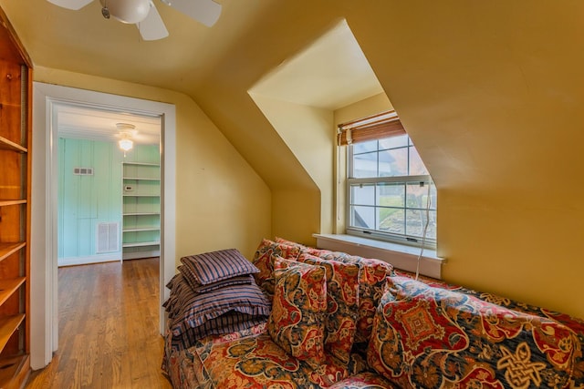 bonus room with ceiling fan, built in features, wood-type flooring, and vaulted ceiling