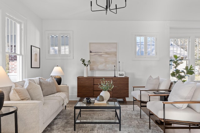 living room with hardwood / wood-style floors and a notable chandelier