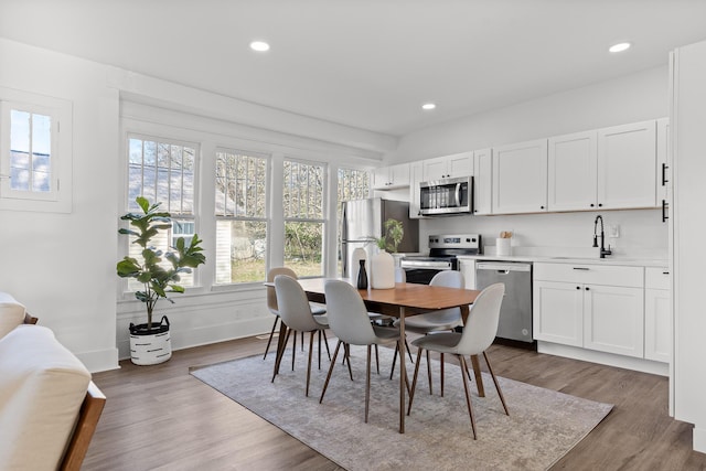 dining area with sink and dark hardwood / wood-style floors