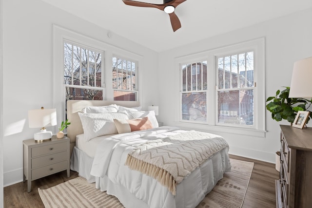 bedroom featuring multiple windows, ceiling fan, and dark wood-type flooring