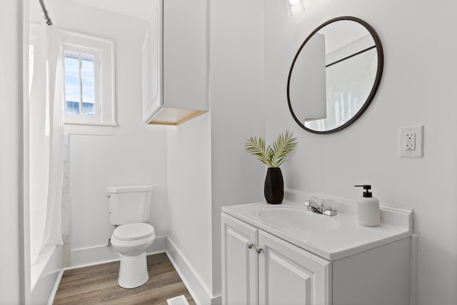 full bathroom featuring vanity, wood-type flooring, shower / bath combo, and toilet