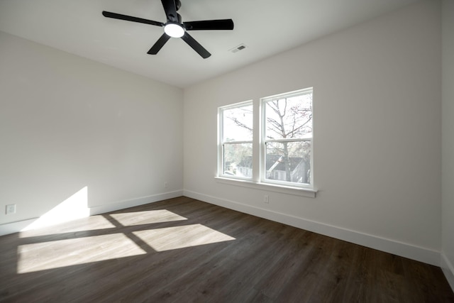 spare room with ceiling fan and dark wood-type flooring