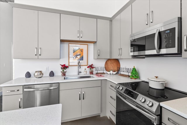 kitchen with gray cabinetry, sink, and appliances with stainless steel finishes