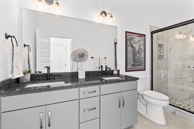 bathroom featuring toilet, a shower with door, vanity, and an inviting chandelier