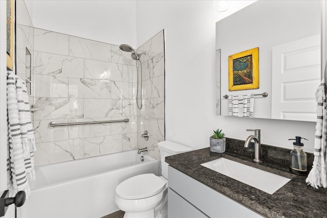 full bathroom featuring vanity, tiled shower / bath combo, and toilet