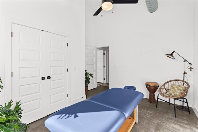 interior space featuring ceiling fan, a high ceiling, and a closet