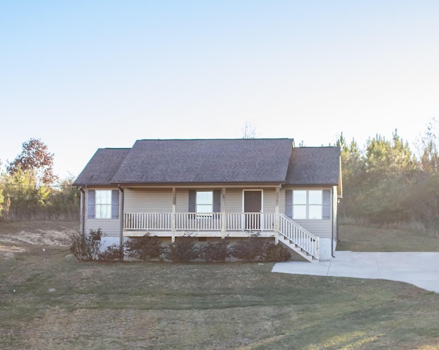 single story home with a porch and a front lawn