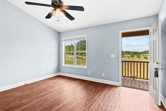 empty room with ceiling fan, light hardwood / wood-style floors, and lofted ceiling