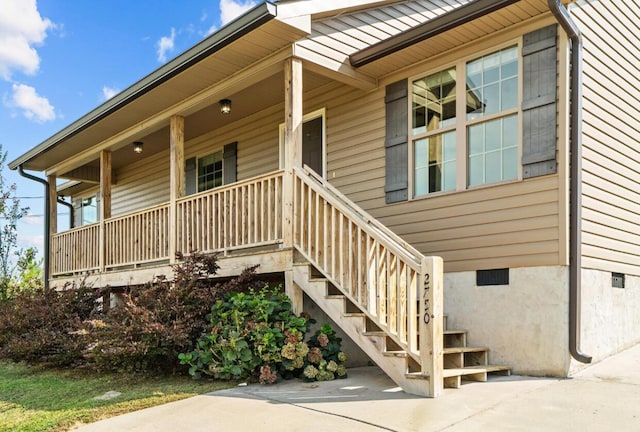 view of exterior entry with covered porch