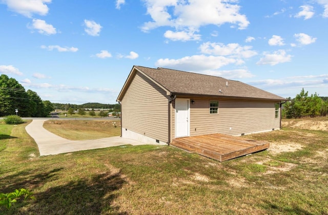 rear view of house with a deck and a yard