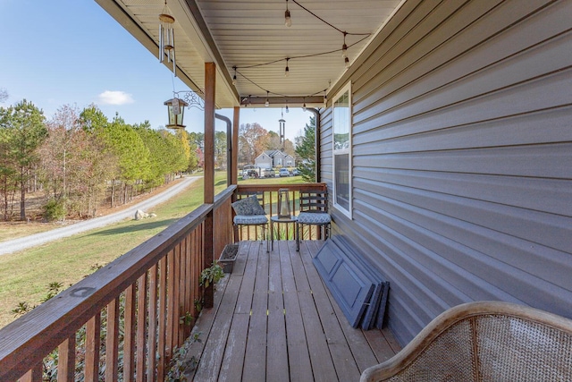 wooden deck with a porch and a yard