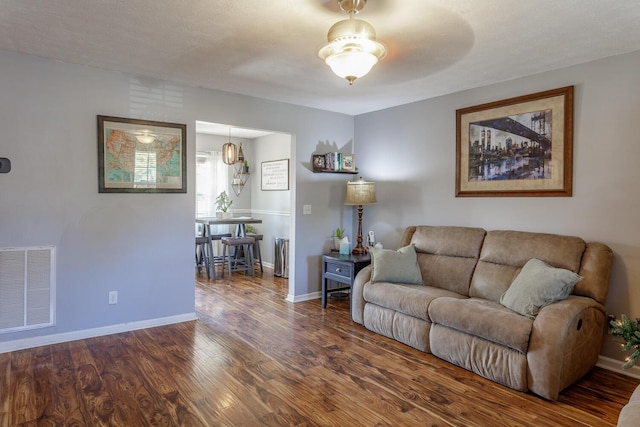 living room with dark hardwood / wood-style flooring