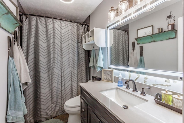 bathroom featuring vanity, toilet, a textured ceiling, and walk in shower