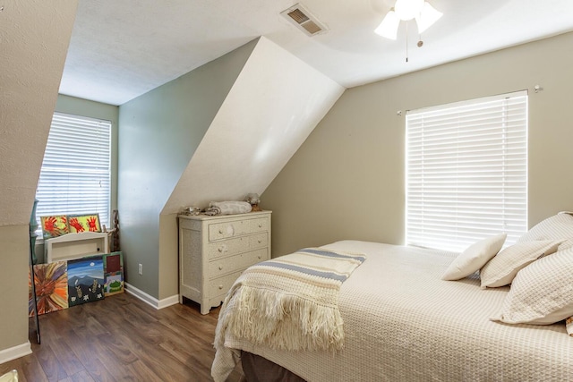 bedroom with ceiling fan, dark hardwood / wood-style flooring, and vaulted ceiling