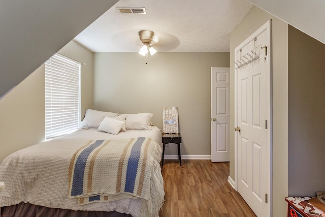 bedroom with hardwood / wood-style flooring and ceiling fan