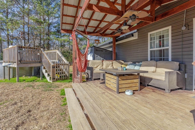 deck featuring an outdoor living space and ceiling fan