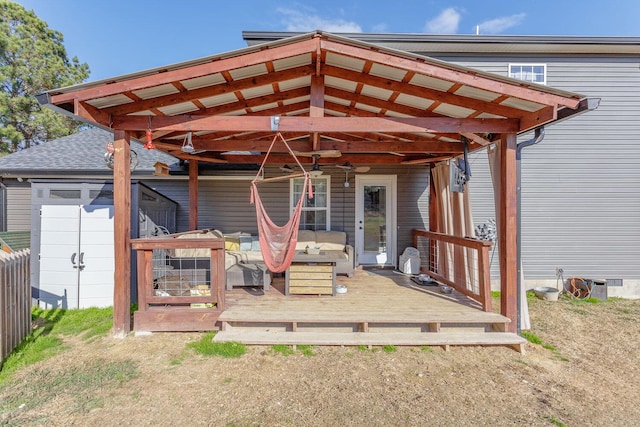 rear view of house featuring a wooden deck