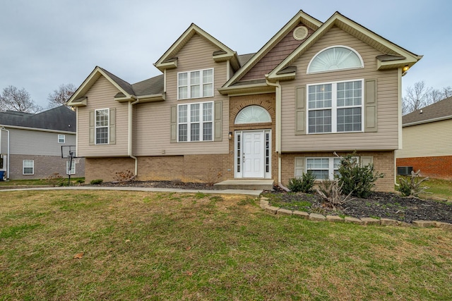 view of front of house with a front lawn and cooling unit